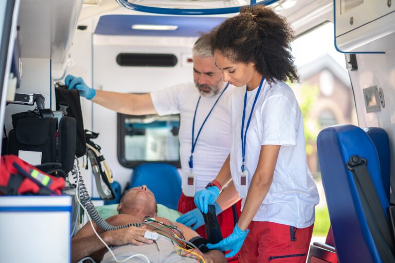 Medical team and patient in the back of a van with equipment